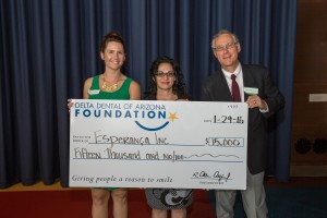 Esperanca's McKenzie Simmons, director of development, and Maria Valenzuela, community health coordinator, accept a $15,000 grant from Delta Dental of Arizona Foundation board member, Dr. Phil Santucci.